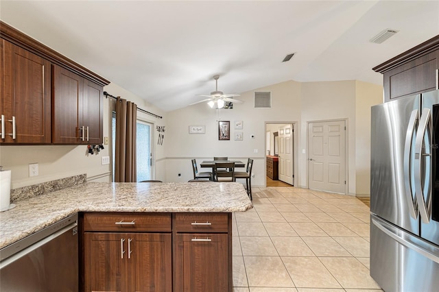 kitchen featuring ceiling fan, vaulted ceiling, dark brown cabinetry, appliances with stainless steel finishes, and light tile patterned floors