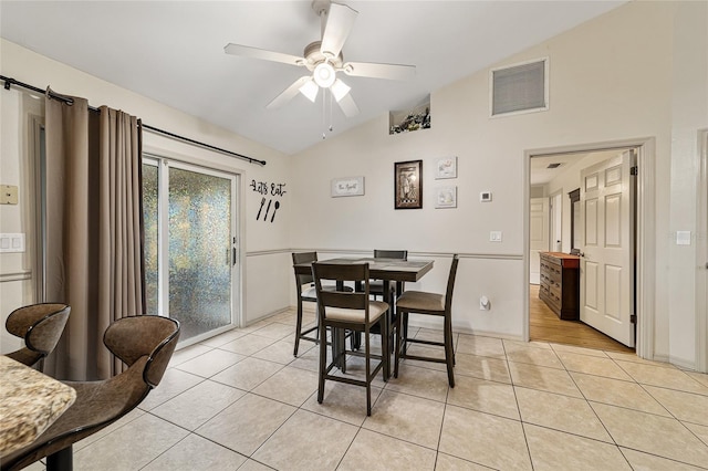 dining area with lofted ceiling, light tile patterned floors, and ceiling fan