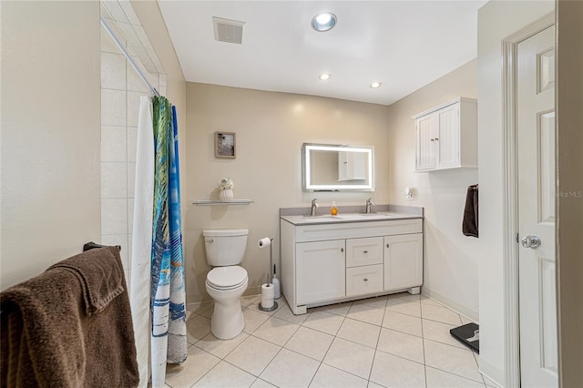 bathroom featuring toilet, vanity, and tile patterned flooring