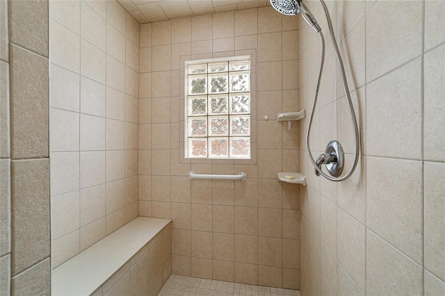 bathroom with a tile shower