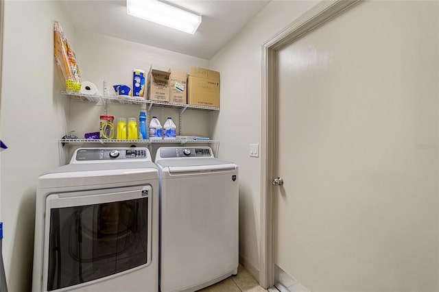 clothes washing area featuring light tile patterned flooring and independent washer and dryer