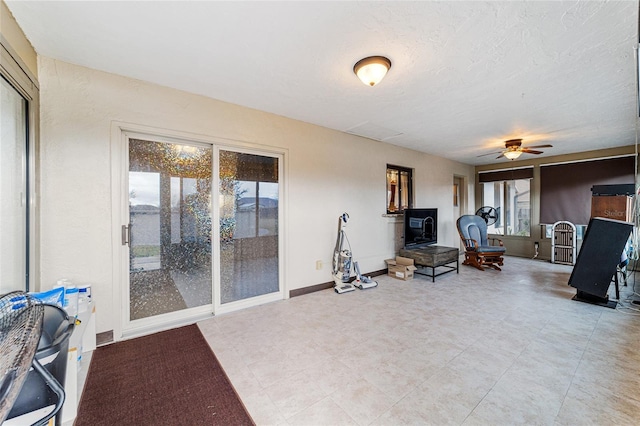 sitting room featuring ceiling fan and a textured ceiling