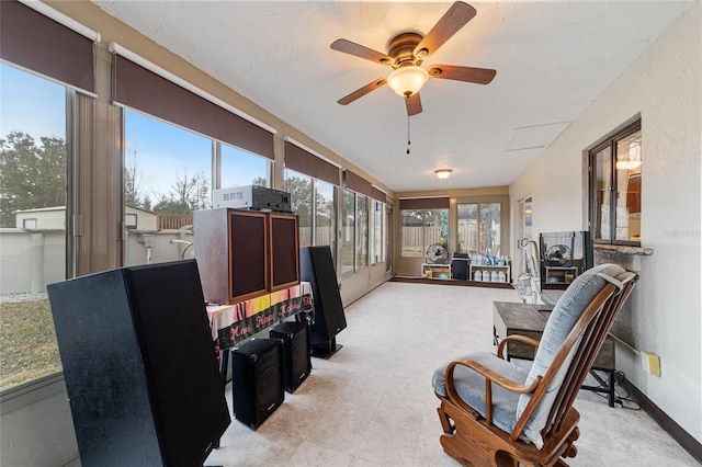 sunroom featuring ceiling fan and plenty of natural light