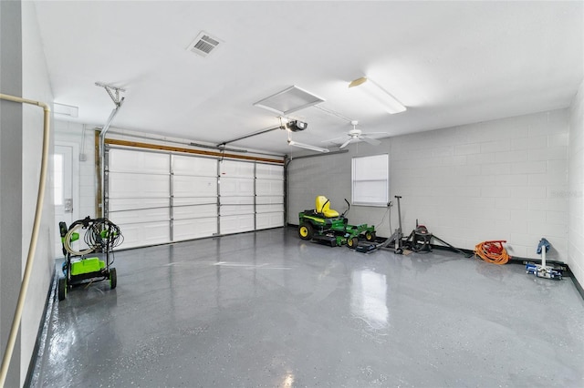 garage with ceiling fan and a garage door opener