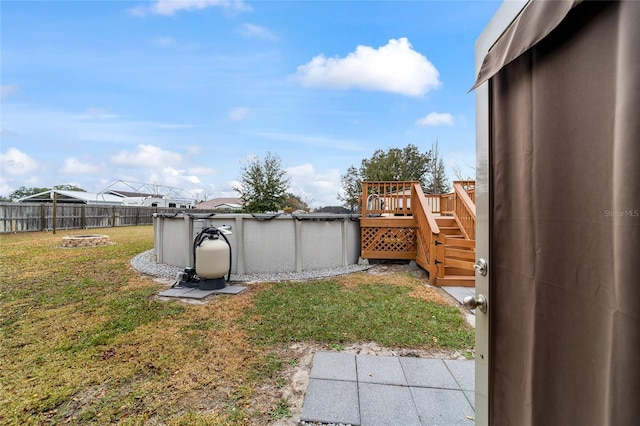 view of yard featuring an outdoor fire pit and a swimming pool side deck