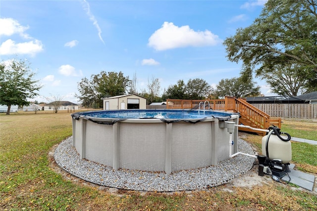 view of pool featuring a lawn and a shed