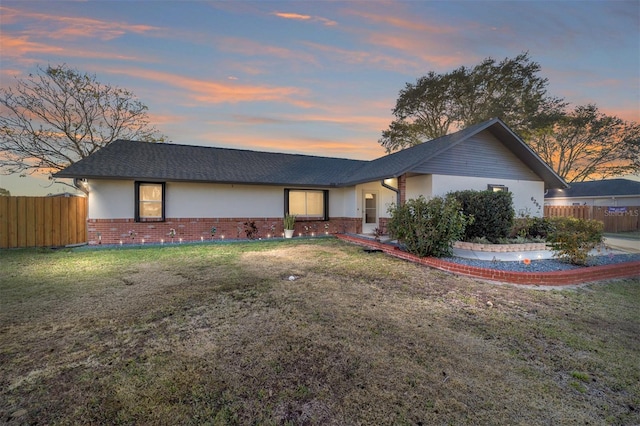 ranch-style house featuring a yard