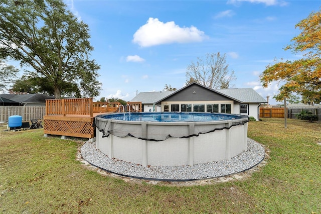 view of pool featuring a deck and a yard