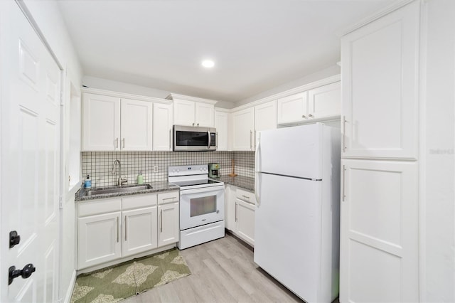 kitchen featuring light hardwood / wood-style floors, decorative backsplash, sink, white appliances, and white cabinetry