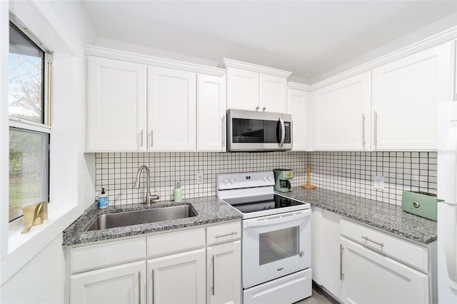 kitchen with white cabinetry, sink, white appliances, and decorative backsplash