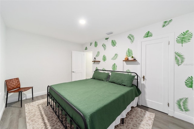 bedroom with hardwood / wood-style floors