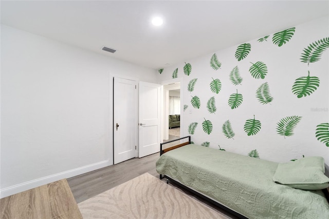 bedroom with light hardwood / wood-style floors