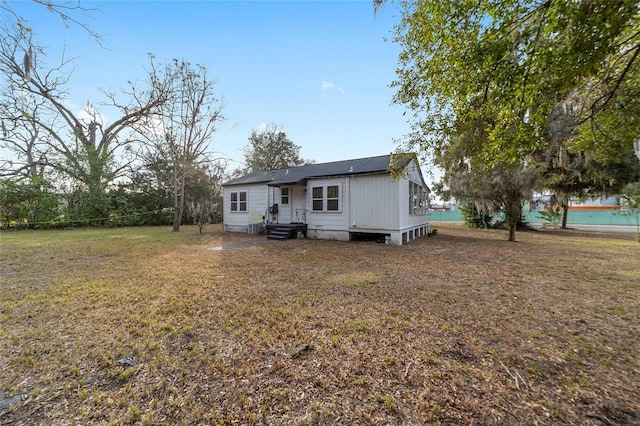 back of house with a yard