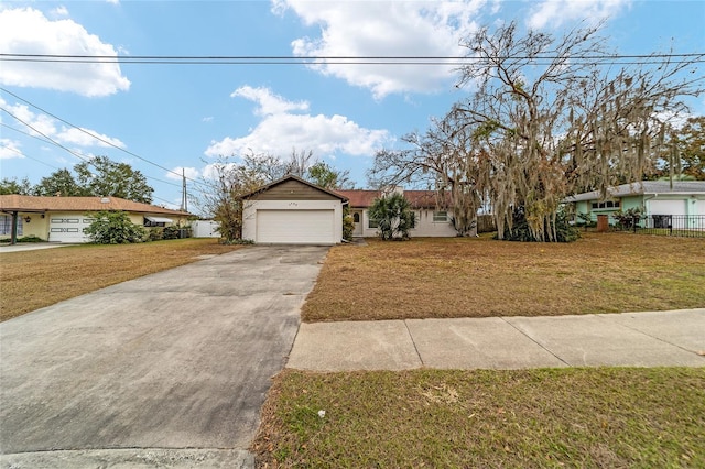 ranch-style home featuring a garage and a front lawn