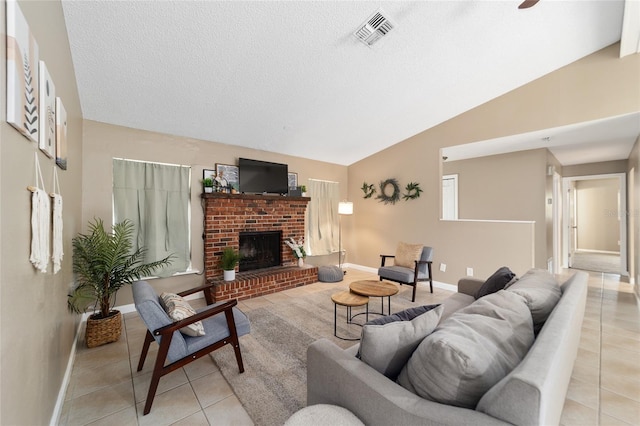 living room with a fireplace, vaulted ceiling, and light tile patterned flooring