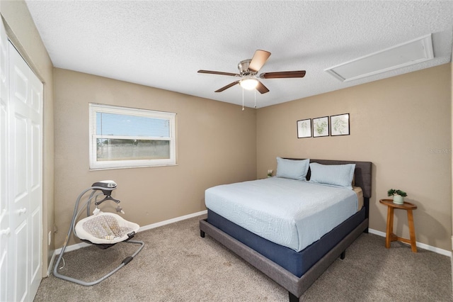 bedroom featuring ceiling fan, a textured ceiling, a closet, and carpet floors