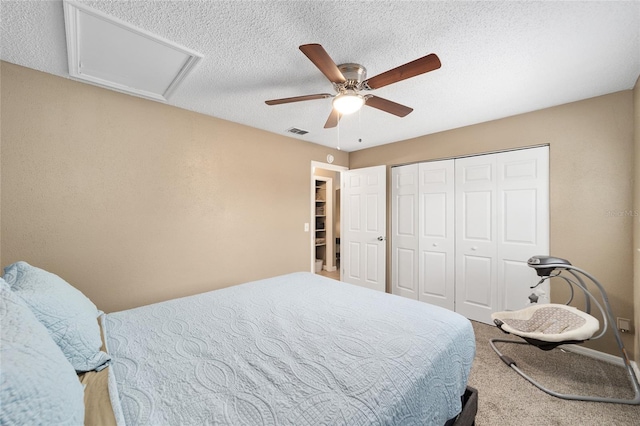 bedroom featuring ceiling fan, a closet, carpet, and a textured ceiling