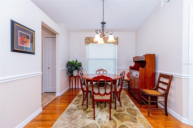 dining room with a chandelier and wood-type flooring