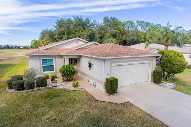 ranch-style house with a garage and a front yard