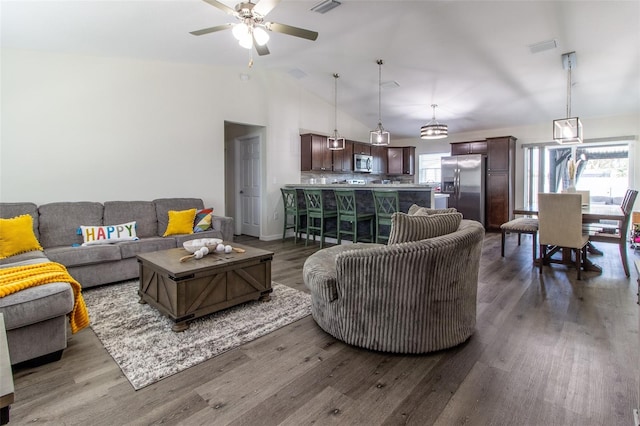 living room featuring ceiling fan, dark wood-type flooring, and lofted ceiling