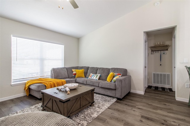 living room with dark hardwood / wood-style floors, a healthy amount of sunlight, and ceiling fan