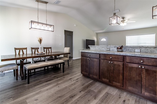 kitchen with dark brown cabinetry, decorative light fixtures, ceiling fan, and hardwood / wood-style flooring