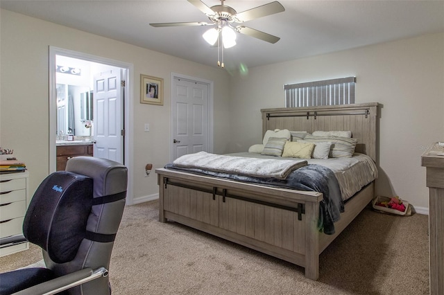 carpeted bedroom with ceiling fan and ensuite bath