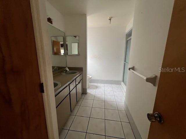 bathroom with tile patterned flooring, vanity, and toilet