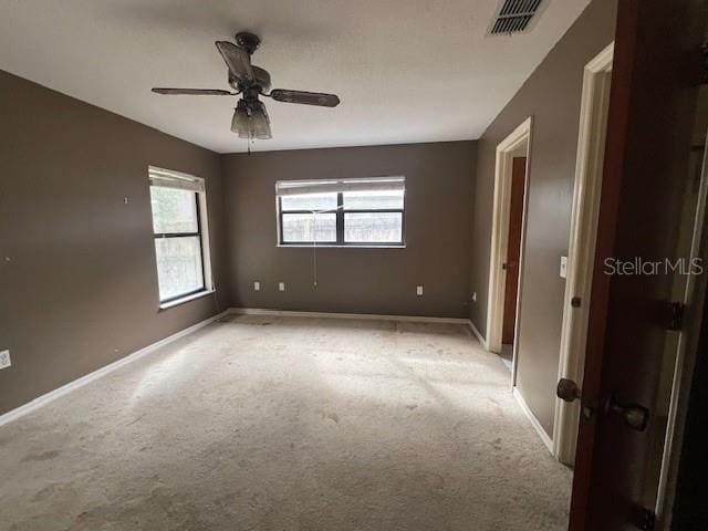 carpeted empty room featuring ceiling fan