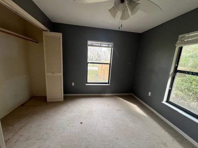 unfurnished bedroom with carpet flooring and ceiling fan