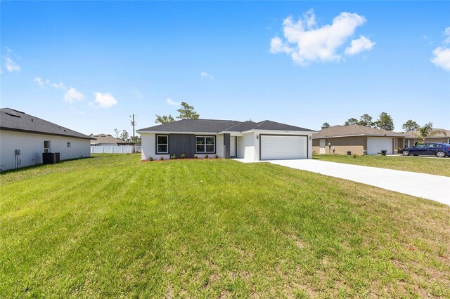 4393 SW 169 Lane Rd, Ocala, FL 34473 - ranch-style house with driveway, an attached garage, and central air condition unit