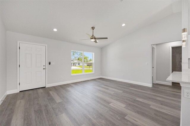 4393 SW 169 Lane Rd, Ocala, FL 34473 - unfurnished living room with ceiling fan, wood finished floors, baseboards, recessed lighting, and lofted ceiling