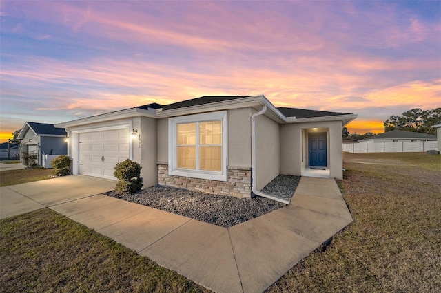 view of front of property featuring a garage and a yard