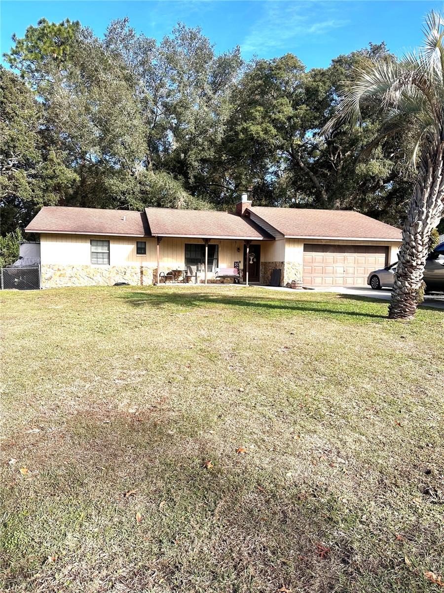 single story home with a front yard and a garage