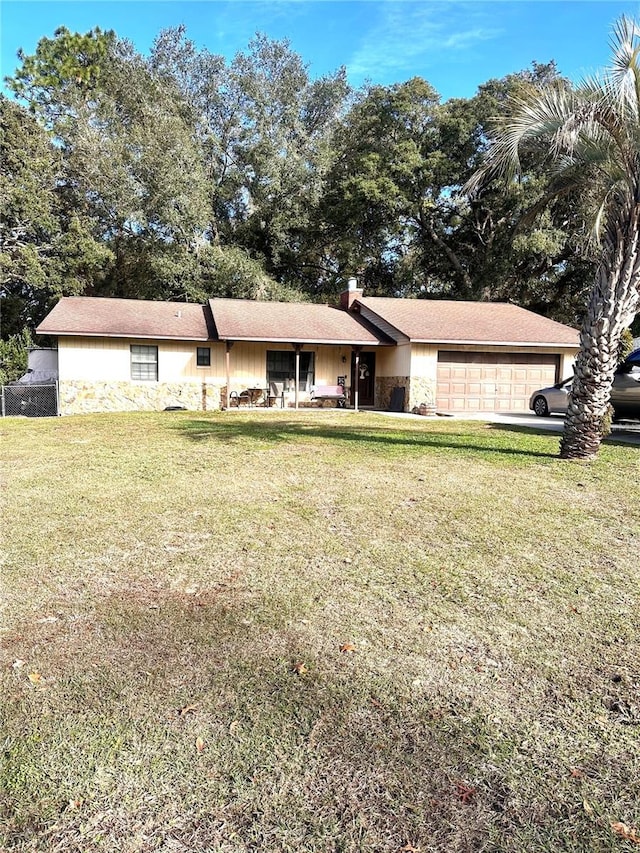 single story home with a front yard and a garage