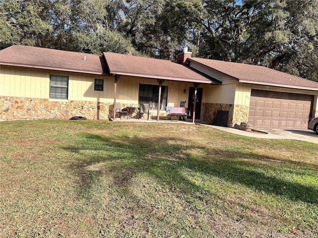 single story home with a front yard and a garage