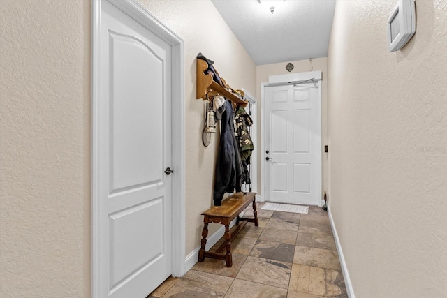 hallway with a textured ceiling