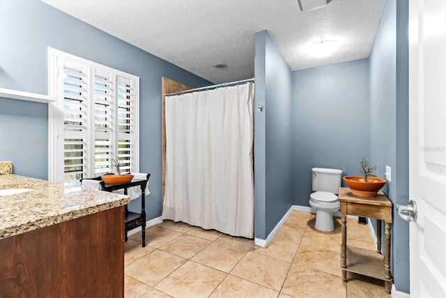 bathroom with walk in shower, tile patterned floors, a textured ceiling, toilet, and vanity