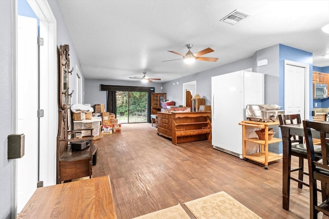 bedroom with light hardwood / wood-style flooring and a textured ceiling