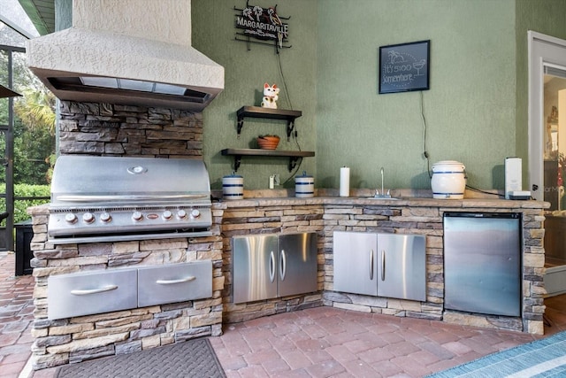 view of patio with sink, area for grilling, and a grill