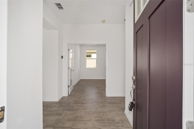 hallway with hardwood / wood-style flooring