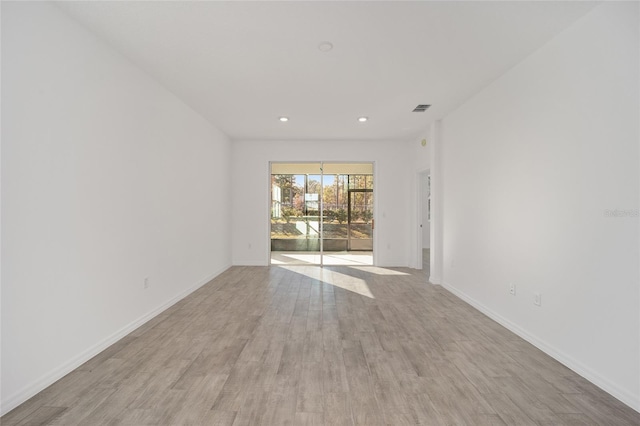 spare room featuring light wood-type flooring