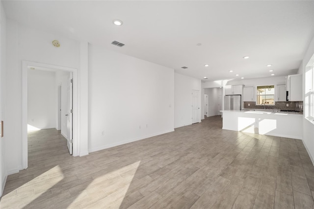 unfurnished living room featuring light hardwood / wood-style flooring