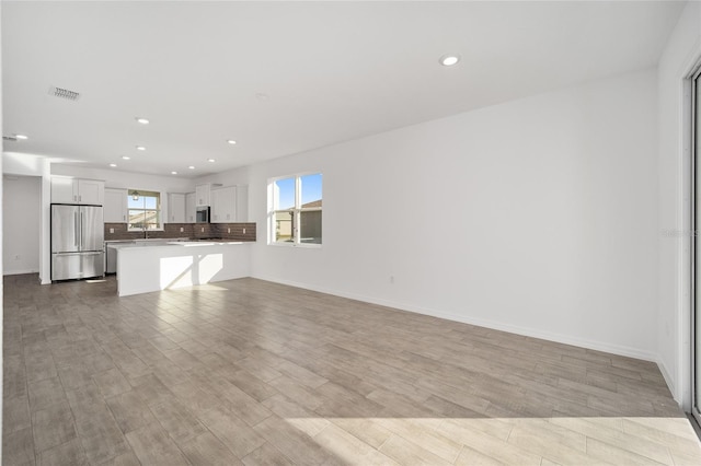 unfurnished living room with light wood-type flooring