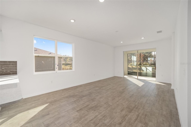 unfurnished room with a healthy amount of sunlight and light wood-type flooring