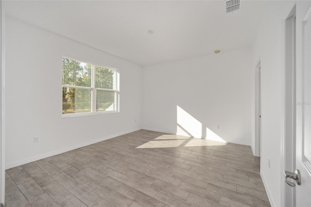 spare room with light wood-type flooring