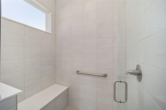 bathroom featuring a shower with door