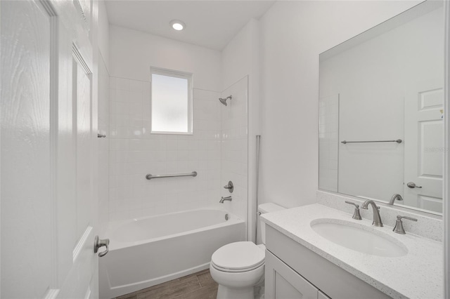 full bathroom featuring toilet, vanity, tiled shower / bath combo, and hardwood / wood-style flooring