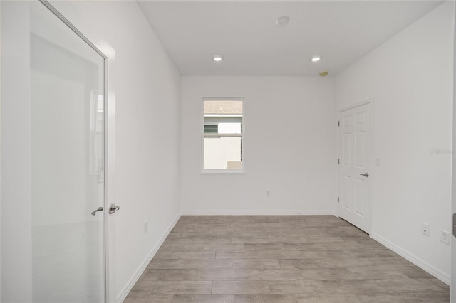 spare room with light hardwood / wood-style flooring