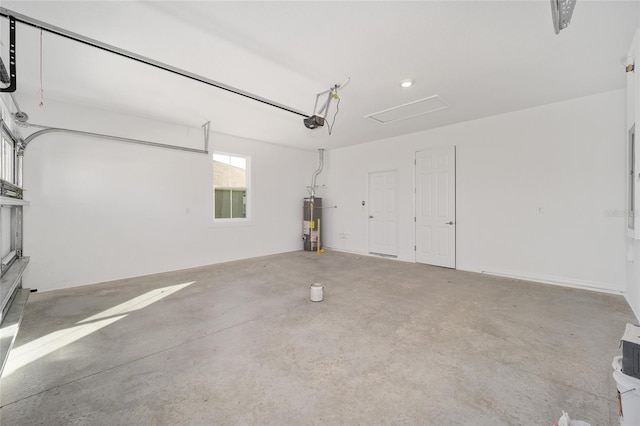 garage featuring a garage door opener and water heater